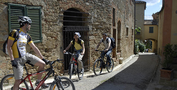 Cyclists exploring local Tuscan villages at Adler Thermae