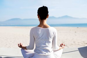 Woman doing yoga on the beach at TIA Wellness Resort in Vietnam