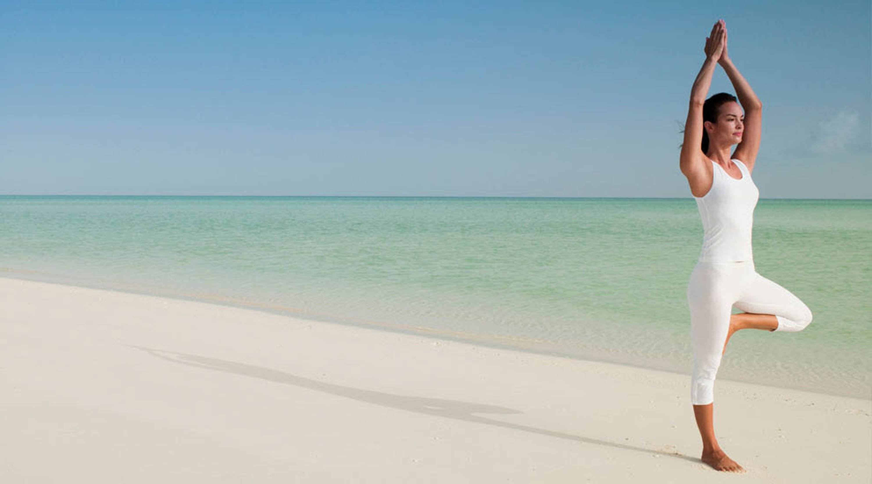 Practise yoga on the beach at Parrot Cay