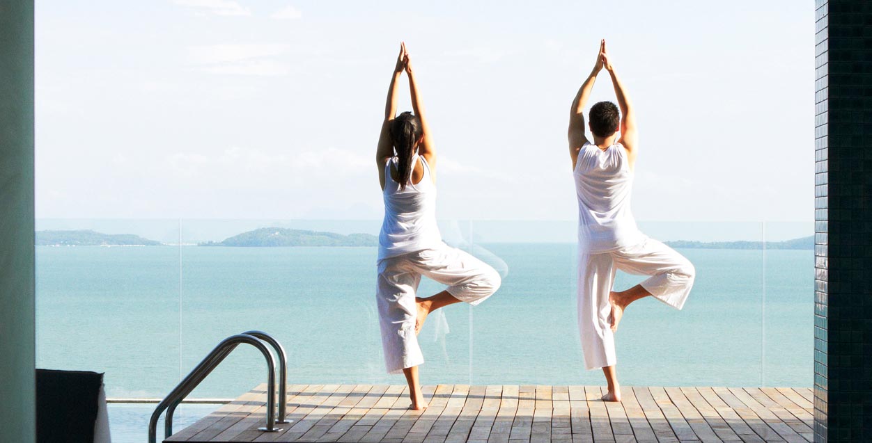 practicing yoga overlooking the sea